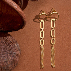 The 14K Real Yellow Gold Unique Chain Dangle Earrings from the Harmony Collection showcase a circular stud and a dangling chain link design, leading to multiple thin chains at the bottom for a tassel-like effect, creating an elegant and hypoallergenic accessory.