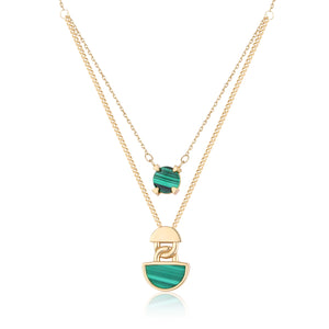 Introducing the 14K Solid Gold Double Layer Malachite Necklace from the Endless Collection. This exquisite piece is crafted from 14K yellow gold and features two captivating malachite gemstone pendants: a small round stone on the shorter chain and a larger semi-circle stone on the longer chain. The necklace's simple yet elegant chains beautifully accentuate the vibrant colors of its pendants.