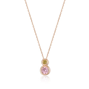 The 14K Solid Gold Mimoza Flower Necklace from the Chloris Collection showcases a sophisticated design with two round gemstones: a smaller yellow stone set above a larger pink one. The custom chain length enhances its minimalist pendant style, offering a hypoallergenic touch ideal for those with sensitive skin.