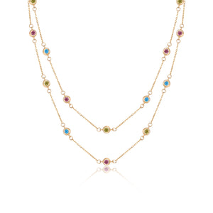 Discover the elegance of the 14K Solid Gold The Beginning Station Chain Necklace from the Chloris Collection. This exquisite piece features two rows of delicate chain links, embellished with evenly spaced, hypoallergenic lab-grown gemstones in pink, blue, and green. The vibrant colors of these stones enhance both beauty and comfort in this sophisticated design.