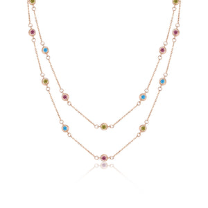 Discover the elegance of the 14K Solid Gold The Beginning Station Chain Necklace from the Chloris Collection. This exquisite piece features two rows of delicate chain links, embellished with evenly spaced, hypoallergenic lab-grown gemstones in pink, blue, and green. The vibrant colors of these stones enhance both beauty and comfort in this sophisticated design.