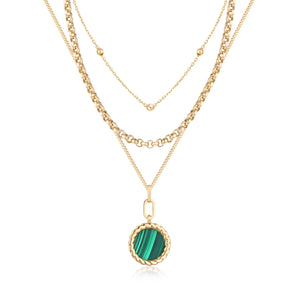 The 14K Solid Gold Natural Malachite 3 Layer Necklace from the Endless Collection displays multiple chains of varying thickness, crafted from real solid yellow gold. The longest chain gracefully features a circular pendant adorned with a natural malachite gemstone, encircled by a twisted gold border, and is meticulously designed to be hypoallergenic.