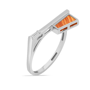 This 14K solid gold ring from the Achates Collection features a modern geometric design, showcasing an orange rectangular carnelian gemstone and a small clear gemstone set into its band. The contemporary style is highlighted by clean lines.