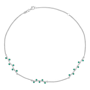 A delicate 14K solid yellow gold piece from the Into the Woods Collection by Erdem Akan, this necklace boasts a fine chain design adorned with small, evenly spaced emerald nano glass-ceramics accents and is elegantly fastened with a simple clasp.