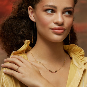 Introducing the 14K Solid Gold Paperclip Station Stacking Necklace from the Harmony Collection: a delicate hypoallergenic gold necklace showcasing a V-shaped center design with elongated rectangular links evenly spaced along the chain. Crafted from 14K real solid yellow gold, it offers multiple chain size options for a simple and elegant aesthetic.