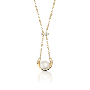 Introducing the 14K Solid Gold Natural Pearl Necklace from the Elegance Collection. This hypoallergenic necklace showcases a natural pearl elegantly set within a gold arc, suspended from a delicate chain. A small diamond cluster adorns the top, adding a touch of sophistication. The piece is beautifully displayed against a white background.