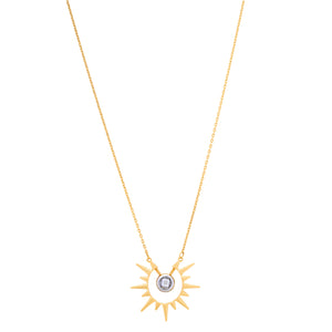 The 14K Solid Gold Sunburst Necklace from the Helios Collection features a sunburst pendant with a central cubic zirconia gemstone, surrounded by elegantly extending spiked rays. It hangs gracefully on a delicate, hypoallergenic chain.