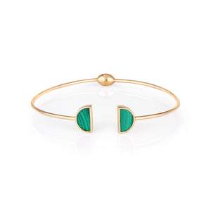 Introducing the 14K Solid Gold Malachite Gemstone Open Cuff Bangle Bracelet from the Endless Collection. This slim accessory showcases a circular design, featuring two semi-circle inlays of natural green malachite at the opening. Hypoallergenic and ideal for sensitive skin, it offers a modern and elegant touch to any outfit.