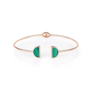 Introducing the 14K Solid Gold Malachite Gemstone Open Cuff Bangle Bracelet from the Endless Collection. This slim accessory showcases a circular design, featuring two semi-circle inlays of natural green malachite at the opening. Hypoallergenic and ideal for sensitive skin, it offers a modern and elegant touch to any outfit.