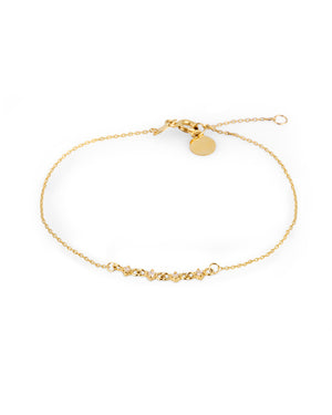 Introducing the 14K Solid Gold Diamond Eucalyptus Flower Bracelet from the Chloris Collection: a delicate bracelet featuring a fine chain and small linked charms at its center. This exquisite piece includes an adjustable clasp complemented by an extension chain, finishing elegantly with a small round disc.