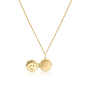 The 14K Solid Gold Heart & Shell Custom Photo Locket Medallion Necklace from the Timeless Collection features a circular pendant crafted in real solid yellow gold, adorned with a small heart design set with red gemstones. This hypoallergenic locket is available on a fine chain in multiple sizes for the perfect fit.