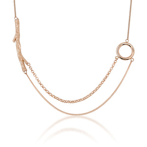 Introducing the 14K Solid Gold Tree Branch in Balance Necklace from the "Into the Woods" Collection by Erdem Akan. This exquisite piece features two distinct chain styles seamlessly connected to a textured branch-like element on one side and a smooth circular loop on the other. Made with sustainable practices, this necklace provides both elegance and peace of mind as it casts a subtle shadow against a white backdrop.