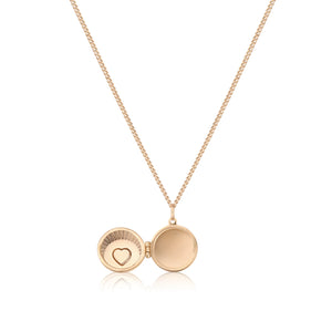 The 14K Solid Gold Heart & Shell Custom Photo Locket Medallion Necklace from the Timeless Collection features a circular pendant crafted in real solid yellow gold, adorned with a small heart design set with red gemstones. This hypoallergenic locket is available on a fine chain in multiple sizes for the perfect fit.