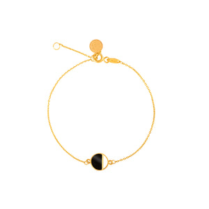 The 14K Solid Gold Black Enamel The First Quarter Moon Chain Bracelet from the Moonlight Collection is a delicate piece featuring a circular black and gold pendant. It includes a clasp with an adjustable extension chain and is designed with hypoallergenic materials for comfortable wear on sensitive skin, presented on a white background.