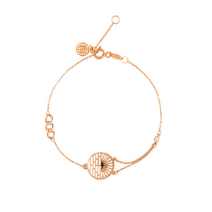 The 14K Solid Gold Sun Ceremony Lab-Grown Diamond Bracelet from the Helios Collection features a circular pendant with intricate geometric designs and a sparkling lab-grown diamond. Delicate chain links of 14K solid gold and a small lobster clasp complete this elegant, hypoallergenic jewelry piece.