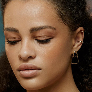 Introducing the 14K Solid Gold Geometric Triangle Hoop Earrings from the Harmony Collection, elegantly designed with a solid and open triangular shape. These beautifully handcrafted earrings offer a modern, minimalist look and are hypoallergenic.