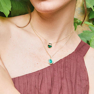 Introducing the 14K Solid Gold Diamond & Malachite Pendant Necklace from our Endless Collection, featuring a circular pendant with a natural malachite gemstone surrounded by small gold beads. This exquisite pendant, crafted from 14K real solid yellow gold, is delicately attached to a fine gold chain and adorned with sparkling crystal accents above.