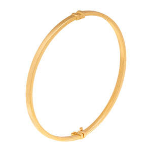 The 14K Solid Gold Plain Shiny Bangle Bracelet from the Harmony Collection offers a simple, elegant design with a smooth finish and a small clasp for secure fastening. Its circular shape boasts a shiny surface that reflects light softly.