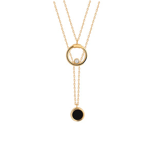 The Moonlight Collection's 14K Solid Gold Enamel Y Chain Drop Necklace showcases a gold double chain in yellow gold, featuring an upper pendant with a petite circular enclosure holding a single diamond, complemented by a lower pendant adorned with a circular black stone. Its hypoallergenic design makes it ideal for individuals with sensitive skin.