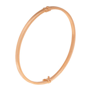 The 14K Solid Gold Plain Shiny Bangle Bracelet from the Harmony Collection offers a simple, elegant design with a smooth finish and a small clasp for secure fastening. Its circular shape boasts a shiny surface that reflects light softly.