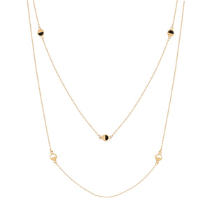 Presenting the 14K Solid Gold Black Enamel Double Layer Chain Necklace from the Moonlight Collection, meticulously crafted from genuine 14K solid yellow gold. This exquisite piece features twin strands decorated with small black and white enamel disks. Made using sustainable methods, its elegant and minimalist design makes it an ideal choice for those looking for hypoallergenic jewelry.