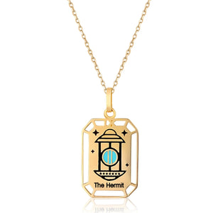 This 14K solid gold necklace from the Tarot Collection features a captivating lantern design on its hypoallergenic pendant, inscribed with "The Hermit" and adorned with intricate geometric cutouts along the border, making it ideal for those with sensitive skin.