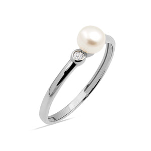 Introducing the 14K Solid Gold Natural Pearl Ring from the Elegance Collection: This exquisite piece is crafted in 14K solid gold and features a large, natural pearl complemented by a small, clear diamond accent on its sleek band. The elegant design highlights the pearl prominently while reflecting sustainable craftsmanship. The ring is elegantly showcased against a plain white background.