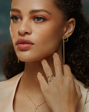 A sleek and sophisticated gold ring from Runda's Harmony Collection, showcased against a white backdrop. This circular 14K solid gold piece highlights its smooth and lustrous texture with a minimalist design, all crafted through sustainable methods.