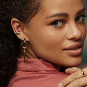 The 14K Solid Gold Bar Drop - Dangle Earrings from the Harmony Collection features a sophisticated circular design with a vertical bar hanging beneath each circle. Expertly handcrafted for comfort, these hypoallergenic earrings feature post backings and are beautifully displayed against a white background.