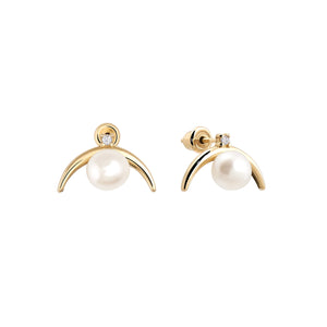 The 14K Solid Gold Crescent Natural Pearl Stud Earrings from the Elegance Collection feature exquisite crescent-shaped designs crafted from genuine solid gold. Each earring showcases a natural pearl centerpiece, accentuated by a small diamond above it for added elegance. Meticulously created using sustainable methods, these earrings are showcased against a plain white background.