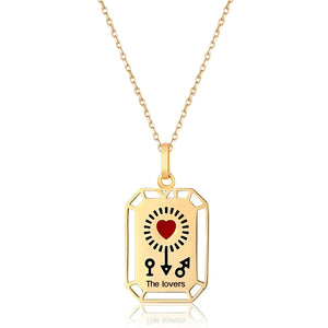 This stunning 14K solid gold necklace from the Tarot Collection, known as "The Lovers," showcases a beautifully detailed tarot pendant. It features a stylized heart with radiant rays at the center, accompanied by a key and keyhole design. Below, the phrase "The Lovers" is elegantly inscribed. The pendant hangs gracefully from a hypoallergenic, delicate chain.