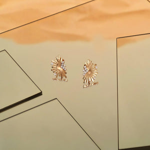 14K Solid Gold Sunburst Stud Earrings from the Helios Collection, featuring a fan-shaped design with radiating spokes and small clusters of hypoallergenic, lab-grown diamonds at the top and bottom.