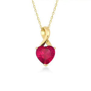 The 14K Gold Heart Shape Ruby Necklace showcases a heart-shaped red cubic zirconia gemstone pendant in a twisted gold setting. This exquisite piece features a fine chain with a simple link design and is crafted from solid 14K gold.