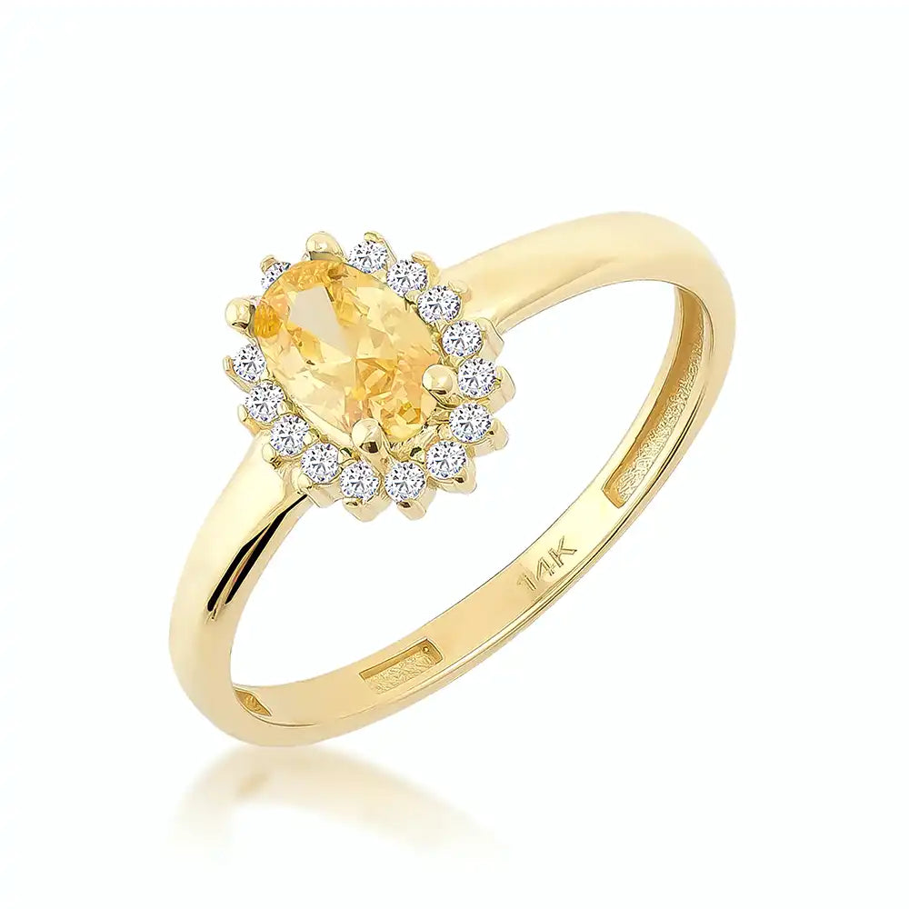 The 14K Solid Gold Citrine November Birthstone Ring features an oval citrine gemstone set in a vintage-style pavé setting with small diamonds arranged in a halo design. The smooth and polished band is crafted from 14K solid gold, marked with "14K" inside, all presented against a plain, light background.