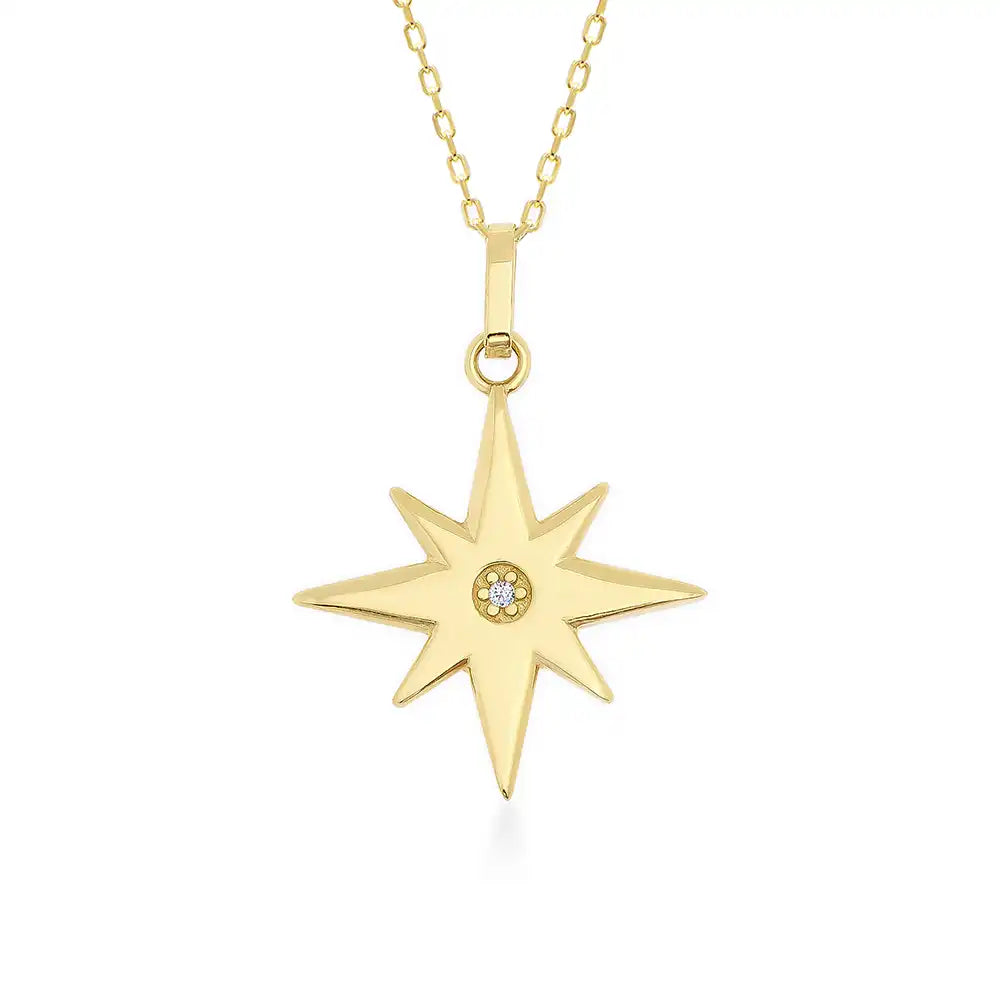 The 14K Gold North Star Pendant Necklace by RundaJewelryUs features a North Star pendant crafted from solid gold with eight symmetrical points and a small central gemstone, hanging elegantly from a delicate chain, making it an ideal graduation gift.