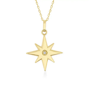 The 14K Gold North Star Pendant Necklace by RundaJewelryUs features a North Star pendant crafted from solid gold with eight symmetrical points and a small central gemstone, hanging elegantly from a delicate chain, making it an ideal graduation gift.