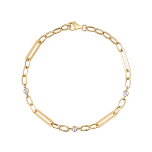 The 14K Gold Paperclip Link Chain Bracelet is a refined piece crafted from solid gold, showcasing an elegant design that alternates between elongated paperclip links and small circular links. It is embellished with three evenly spaced, small round diamonds along the chain, making it perfect for layering. The bracelet secures with a lobster clasp.