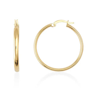 A pair of 14K Gold Round Hoop Earrings displayed on a plain white background features one earring shown from the side, showcasing its sleek, modern round shape and smooth finish, while the other is presented from the front, emphasizing its lightweight clasp mechanism.