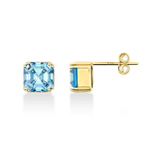 Presenting a stunning pair of 14K Gold Aquamarine Stud Earrings from Runda Jewelry. One earring is displayed from the front, emphasizing the vibrant aquamarine gemstone, while the other is shown from the side to beautifully showcase its elegant gold setting and post.