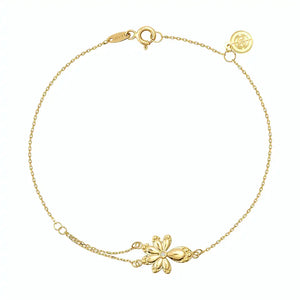 The 14K Solid Gold Diamond Leaf Bracelet from the Chloris Collection showcases a delicate chain link design with a captivating floral charm at its center, making it an ideal bridesmaids' gift for a forest wedding. The simple spring ring clasp and small circular tag provide an elegant touch against the plain white background.