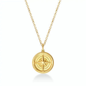 The 14K Solid Gold Compass Necklace for Men showcases a circular pendant with a raised compass design, crafted from solid gold. Its textured edges and polished finish add elegance, while it gracefully hangs on a delicate chain.