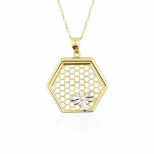 The 14K Gold Queen Bee Pendant Necklace by RundaJewelryUs features a stunning hexagonal honeycomb pendant, beautifully embellished with a delicate bee design, and gracefully suspended on a fine chain.