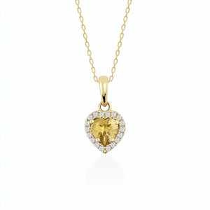 Introducing the 14K Gold Heart Shaped Citrine Necklace for women, featuring a central yellow citrine gemstone beautifully encircled by a halo of petite white diamonds, elegantly set against a simple light backdrop.