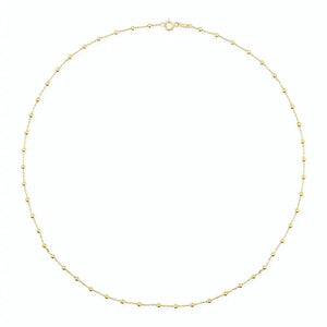 Introducing the 14K Gold Station Minimal Chain Necklace, showcasing a delicate chain adorned with small, evenly spaced beads against a plain white backdrop. This sophisticated piece is equipped with a simple clasp at the top center, making it ideal for layering with other jewelry.