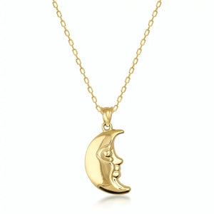 The 14K Real Gold 3D Puffed Moon Necklace is skillfully crafted from exquisite real gold and showcases a crescent moon pendant with an artful face profile. This celestial jewelry piece elegantly hangs from a delicate gold chain against a white background.