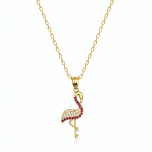 The 14K Solid Gold Ruby Flamingo Necklace features a flamingo-shaped pendant embellished with shimmering red and clear gemstones, making it an elegant gift for her.