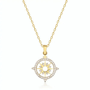 Introducing the 14K Gold North Star and Compass Graduation Necklace, featuring a sunburst pendant crafted from solid 14K gold. This intricately designed piece is adorned with small clear stones, capturing a bright elegance reminiscent of the North Star's guiding light.