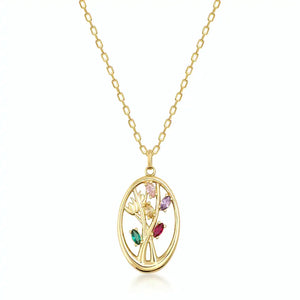 The 14K Solid Gold Birthstone Tree Pendant Necklace features a gorgeous pendant with an abstract tree design. It is set against a plain white background and showcases branches enhanced with multicolored gemstones in green, red, and purple, all enclosed within an oval frame.