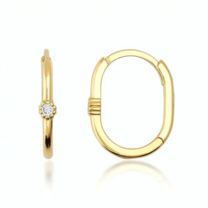 Displayed side by side are two elegant and minimalist hoop earrings from RundaJewelryUs. The left earring showcases a small diamond set in a flower-like design, while the right earring is part of the 14k Solid Gold Oval Solitaire Small Hoops collection, featuring a smooth, oval shape. Both earrings have a shiny finish that embodies the timeless allure of gold jewelry.