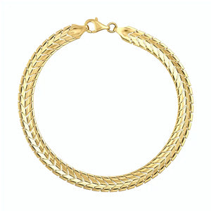 The 14K solid gold snake bracelet, with a smooth, glossy finish and secure clasp, forms an elegant circle. Its intricate pattern reflects light beautifully, showcasing the allure of exquisite gold jewelry.